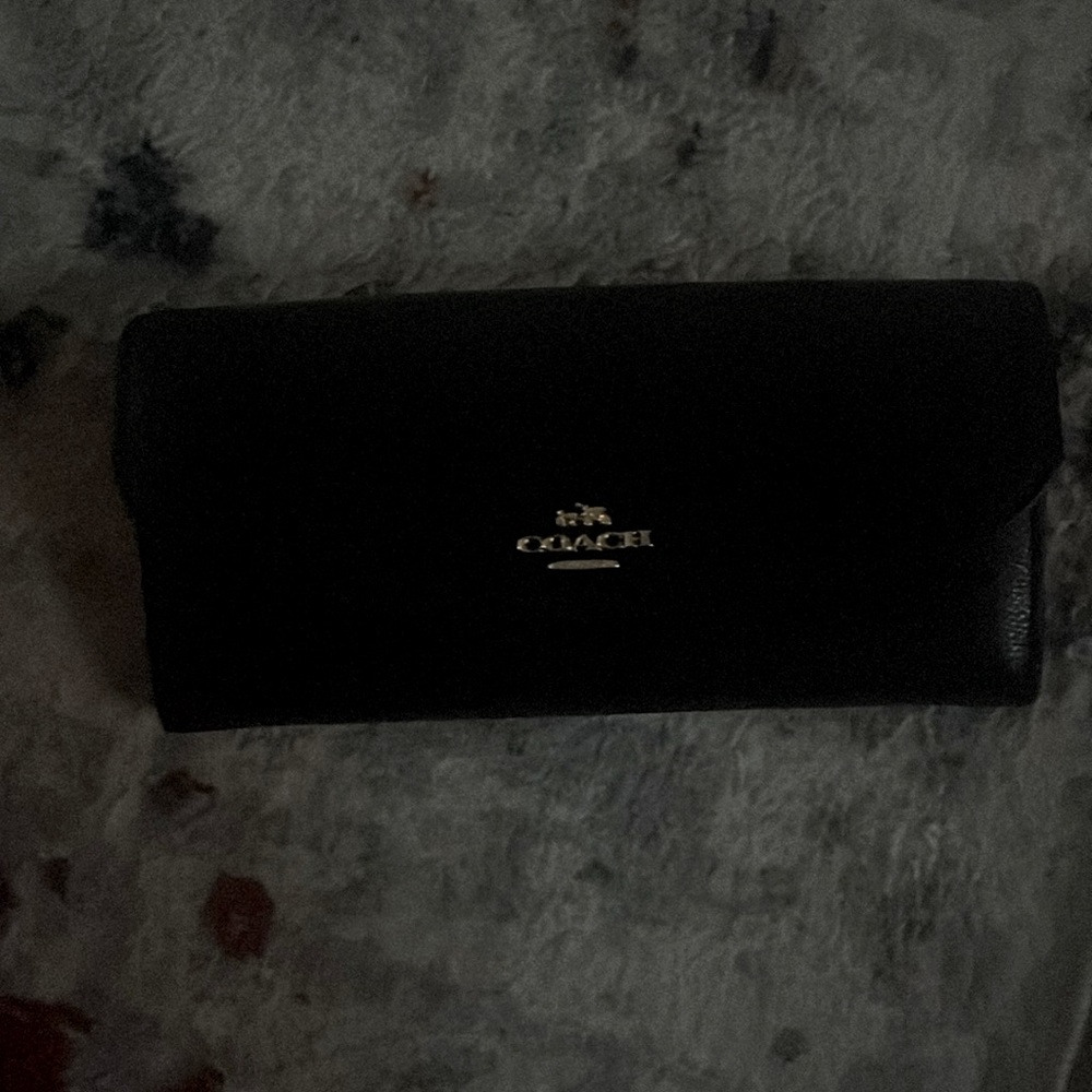 Black and gold coach wallet , used once very beautiful no marks or scratch’s .